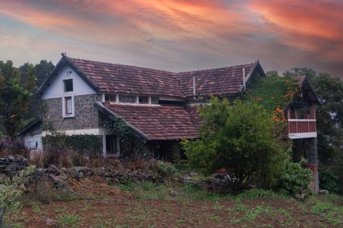 an old house with a roof on a hill at Hullathy by Red Earth in Ooty