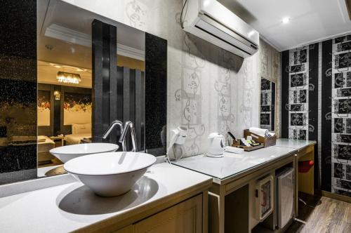 a bathroom with a large bowl sink and a mirror at S One Hotel in Busan