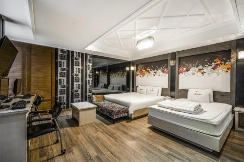 a bedroom with two beds and a kitchen in it at S One Hotel in Busan