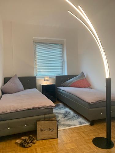 a room with two beds and a box on the floor at Wohnung Nähe Steyr bis 9 Personen in Ramingdorf