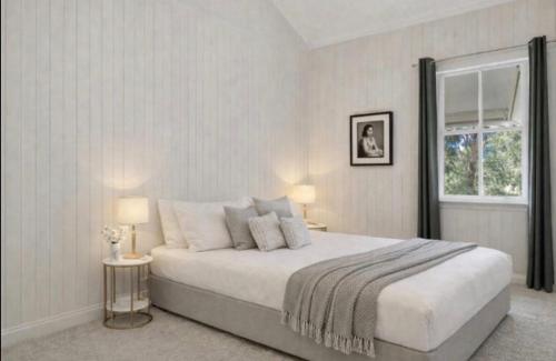 a bedroom with a large bed and a window at Addisons Baroon A Rainforest Retreat with Heated Plunge pool in Montville