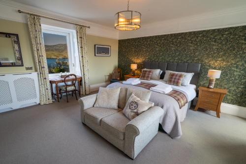 a bedroom with a bed and a chair and a couch at Two Harbours Guest House in Scalpay