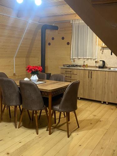 a dining room table and chairs in a kitchen at Guesthouse Venera in Mestia