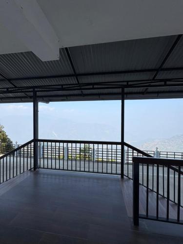 a view from the top of a building with a balcony at Delohighs in Kalimpong