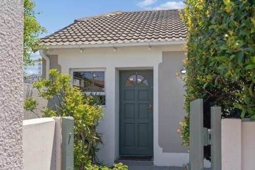 a green door of a house with a fence at Lloyd's Corner in Cape Town