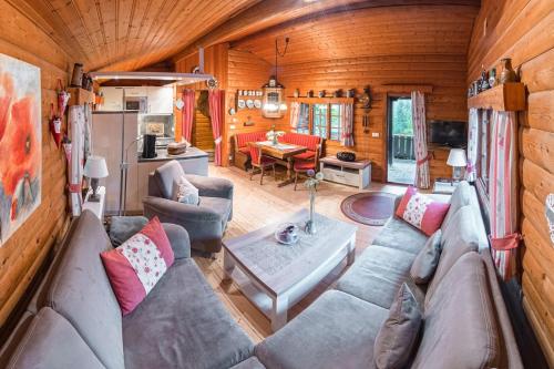 a living room with a couch and a table at Schwedenhaus Uplandalm Willingen in Bömighausen