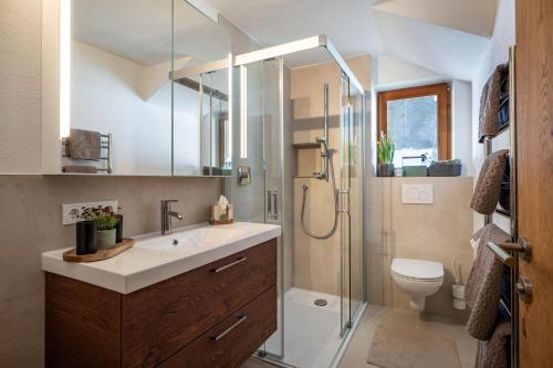 a bathroom with a sink and a shower at Appartement Penningdörfl in Hopfgarten im Brixental
