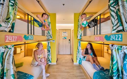 a group of people sitting on bunk beds at Lub d Koh Samui Chaweng Beach - Beachfront & Vibrant Social Vibe in Chaweng