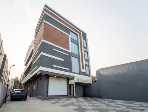 a building with a car parked in front of it at Treebo Shridhar Stay, 2 km from Indore Junction in Indore