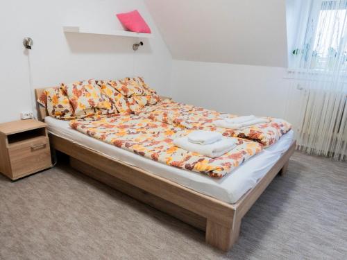 a bed with two towels on it in a room at Katyca Apartman in Balatonfüred