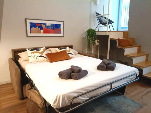 a bed with towels on it in a room at Casa degli Specchi- Duplex in Arona city center - By Guestaly in Arona