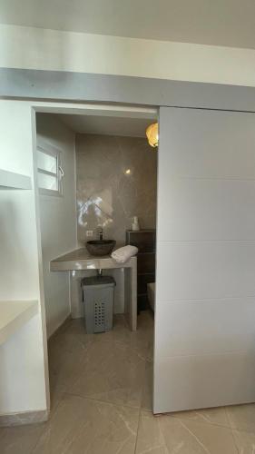 a bathroom with a sink and a toilet in a room at Les Terrasses du Fort in Basse-Terre