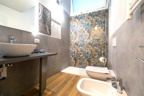 a bathroom with a sink and a toilet at Casa degli Specchi- Duplex in Arona city center - By Guestaly in Arona