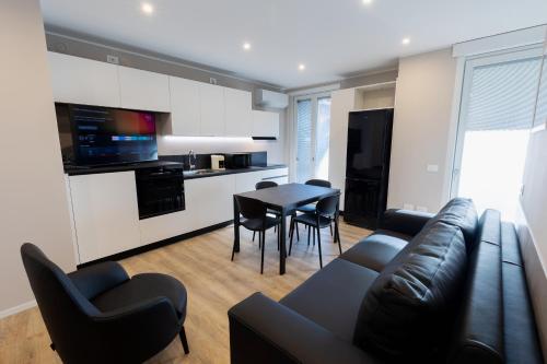 a living room with a couch and a table and chairs at Residenza CONCORDIA in Sondrio