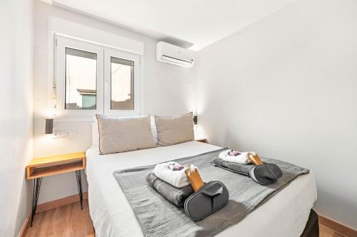 a bedroom with a bed with two bags on it at Merced luxury in Málaga