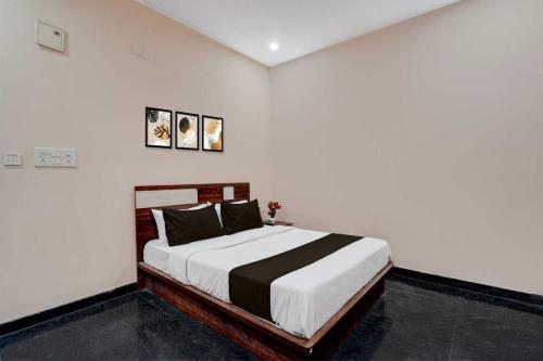 a bedroom with a bed in a white room at Collection O Delta Electronics Metro Station Bangalore Formerly New Kick in Kammasandra