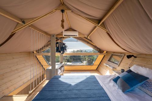 a bedroom with a bed in a tent at Procida Camp & Resort - Ciraccio in Procida