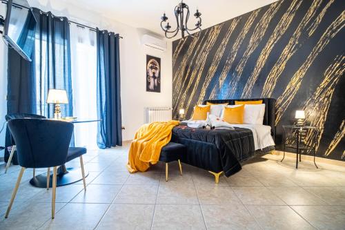 a bedroom with a bed with a yellow blanket on it at Suite del Corso in Ficarazzi