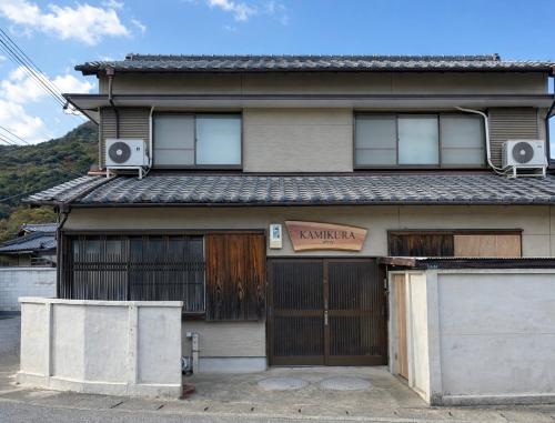 an old house with two garage doors and speakers at KAMIKURA stay in Shingū