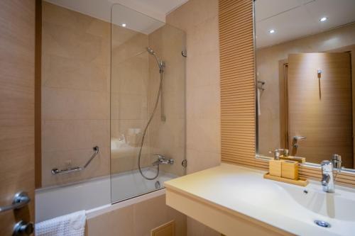 a bathroom with a sink and a shower at LaRin Residence in Bucharest