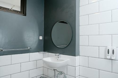 a bathroom with a sink and a mirror at Hau Batu Karas in Batukaras