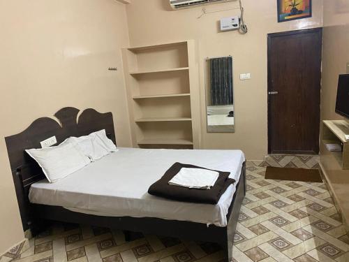 a bedroom with a bed with a wooden headboard at ComfortInn in Chennai