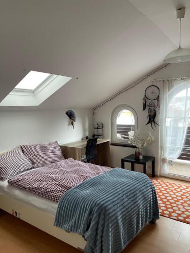 a bedroom with a bed and two windows at Beim Wiesbau‘r in Pichl bei Wels