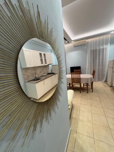 a mirror on a wall in a living room at Hotel Dragoi in Velipojë