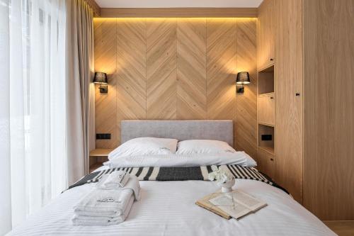 a bedroom with a bed with two towels on it at Apartamenty 3 Owce z widokiem na Giewont in Kościelisko