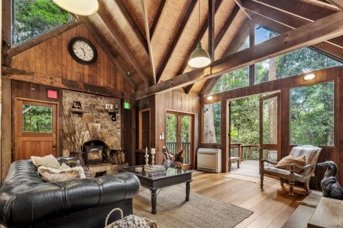 a living room with a couch and a fireplace at Rustic 3-Bed Retreat in Springbrook in Springbrook