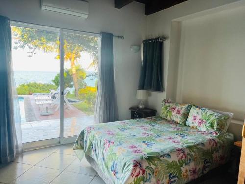 a bedroom with a bed and a view of the ocean at Paradise Beach House in Vilanculos