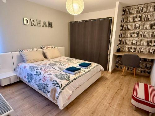 a bedroom with a bed and a chair in it at La Bulle d Avenir in Corcieux