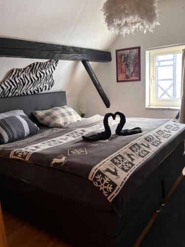 a bed with a zebra blanket on top of it at Ferienhaus Olsberg in Olsberg