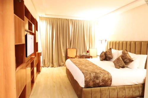 a hotel room with a bed and a television at Royal Mirage Agadir in Agadir