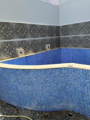 a blue tiled bath tub in a bathroom at Villa haut standing vue mere in Kenitra