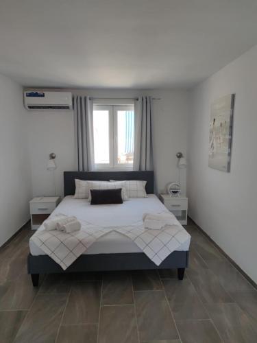 a bedroom with a large bed and a window at Music Vir Apartment in Vir