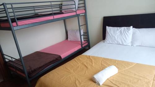 a bedroom with two bunk beds and a bed at Vimalla Hills 2br Private pool, bebas Jam cekin, cekout sesuai jam cekin 24 jam,081tiga80satu6415satu in Gadok 1