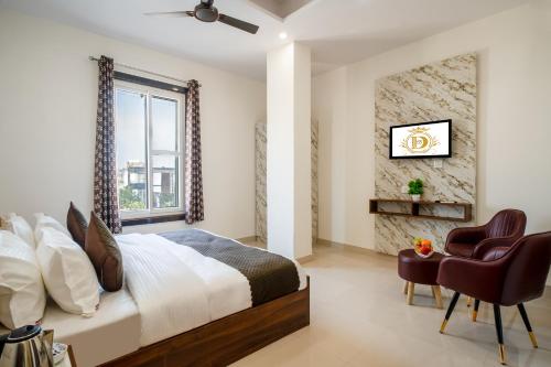 a bedroom with a bed and a window and a chair at Hotel Delhi 53 Near ISBT Kashmiri Gate in Delhi