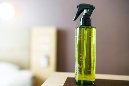 a green spray bottle sitting on top of a table at Super Hotel Premier Tokyo Station Yaesu-Chuoguchi in Tokyo