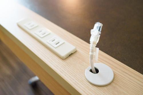 a remote control sitting on top of a table at Super Hotel Premier Tokyo Station Yaesu-Chuoguchi in Tokyo