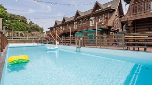 a large swimming pool with a person in a raft at Daecheon Ocean Forest Pension in Boryeong