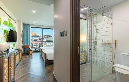 a bathroom with a shower and a bedroom at The Green Hotel Vientiane in Vientiane