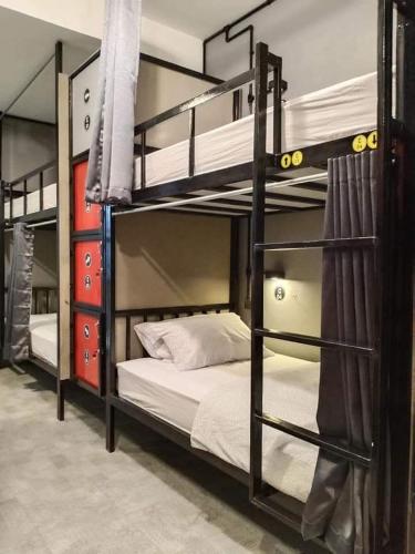 two bunk beds in a room with a bed at Thesleeperhomestay in Ban Chuk Kum