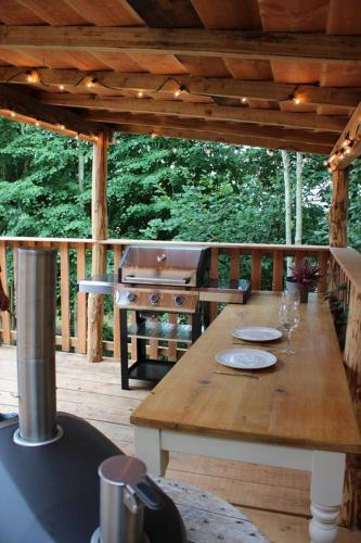 a wooden table on a wooden deck with a tableablish at Journeyman in Bromyard