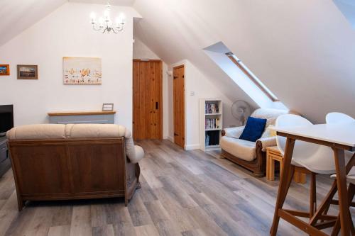 a living room with a couch and a table at Dartmoor Barn on North Hessary Tor in Yelverton