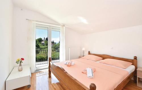 a bedroom with a large bed and a large window at Villa Cascata in Trilj