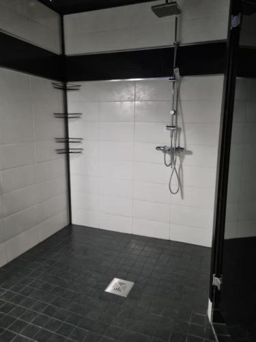 a room with a shower with a tile floor at Villa Sara in Kalajoki