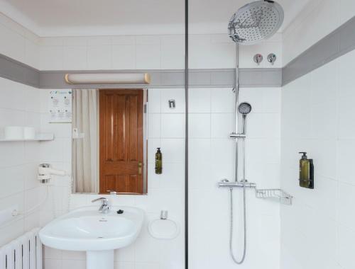a bathroom with a sink and a shower at Hotel S'Agoita in Platja d'Aro