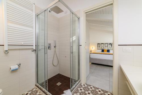 a shower with a glass door in a bathroom at Zia Pupetta Suites in Amalfi