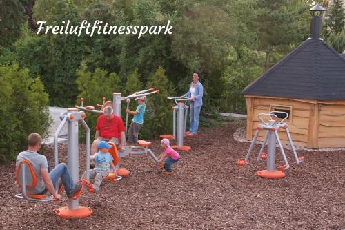 a group of people playing on an outdoor playground at Ferienwohnungen Margaretenhof am Plauer See in Brandenburg an der Havel